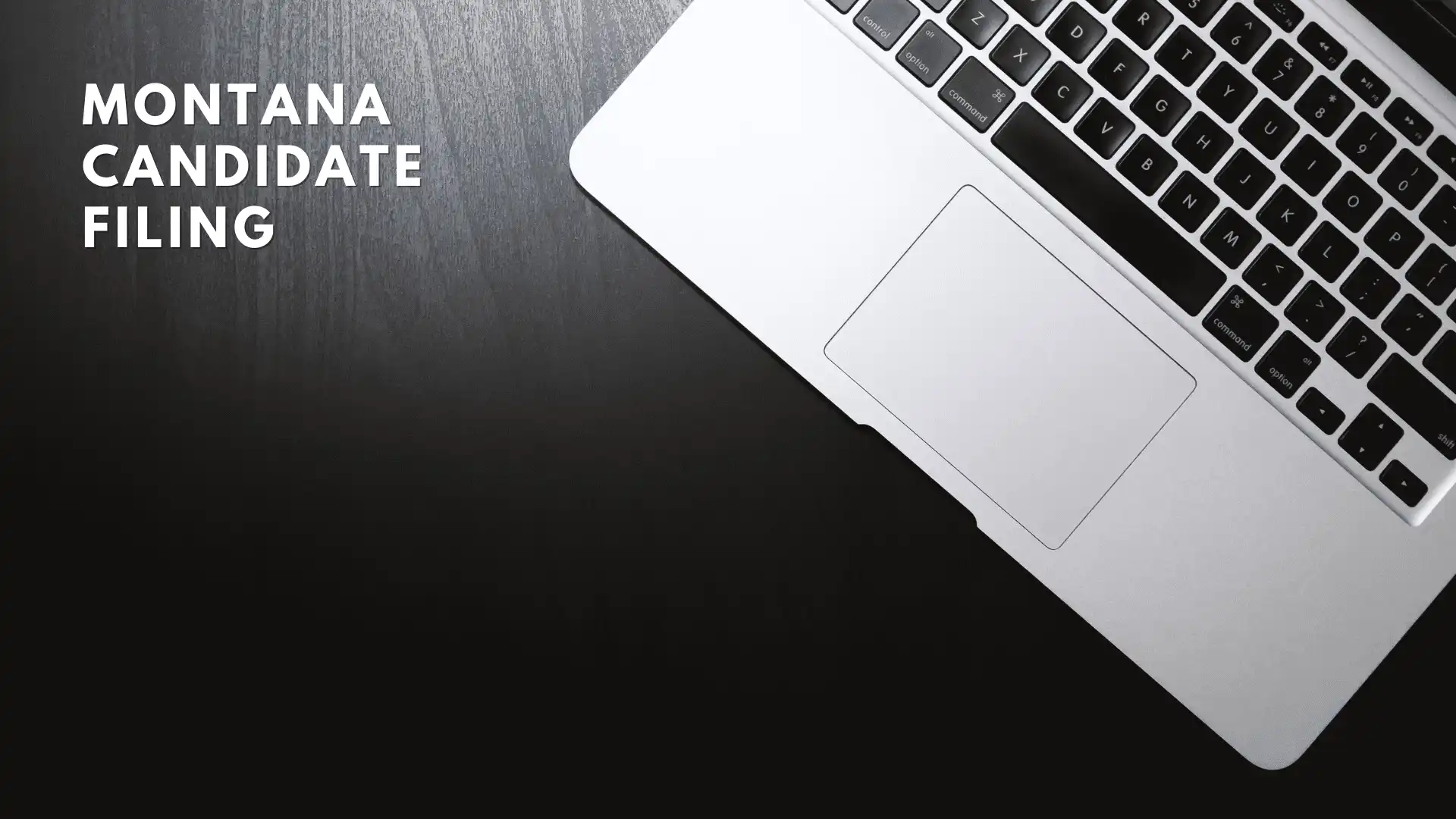 Montana Secretary of State's Office processes 154 candidate filings in first 9 days 6 A silver laptop on a dark wooden surface with the text Montana Candidate Filing in bold white letters on the left side, highlighting candidate filings for upcoming elections by the Montana Secretary of State.