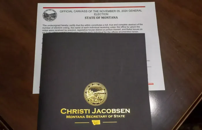 Montana Board of State Canvassers completes state canvass for 2024 General Election 1 A black folder with a gold Montana state seal and Christi Jacobsen, Montana Secretary of State rests on top of an official state document for the November 5, 2024 general election.