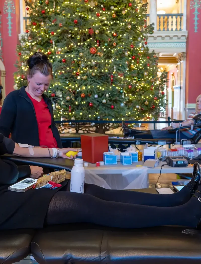Secretary Christi Jacobsen donates blood at the Montana State Capitol.