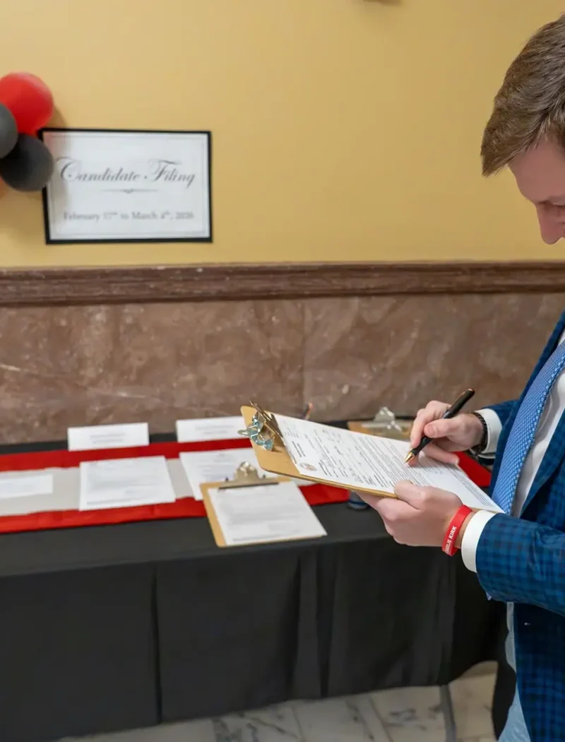 Rep. Braxton Mitchell completes the paperwork to file for office on the opening day of the 2026 candidate filing period.
