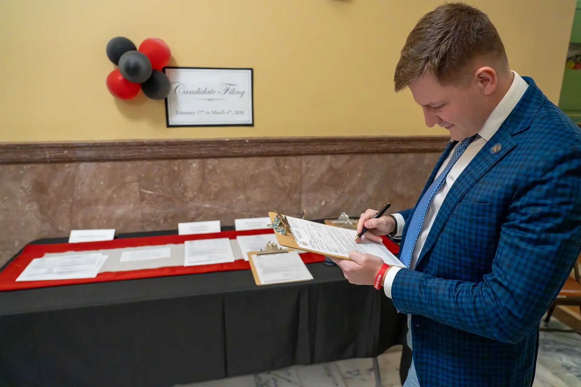 Rep. Braxton Mitchell completes the paperwork to file for office on the opening day of the 2026 candidate filing period.