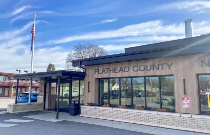 Secretary of State's Office provides hands-on education with Flathead County elections team 9 A beige building with large windows displays the words FLATHEAD COUNTY on its exterior under a blue sky with wispy clouds. An American flag stands near the entrance, highlighting where Flathead County elections are held.