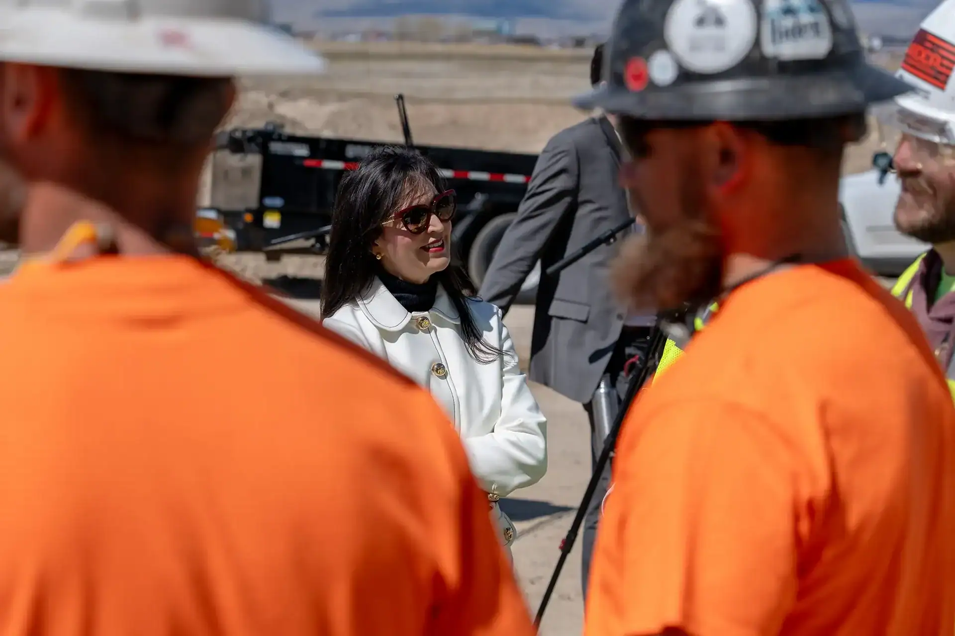 Montana Secretary of State Christi Jacobsen visits with a construction crew on site.