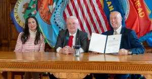 Montana Secretary of State Christi Jacobsen, Montana State Senator Mike Cuffe, and Montana Governor Greg Gianforte at a bill signing ceremony in the Montana State Capitol.