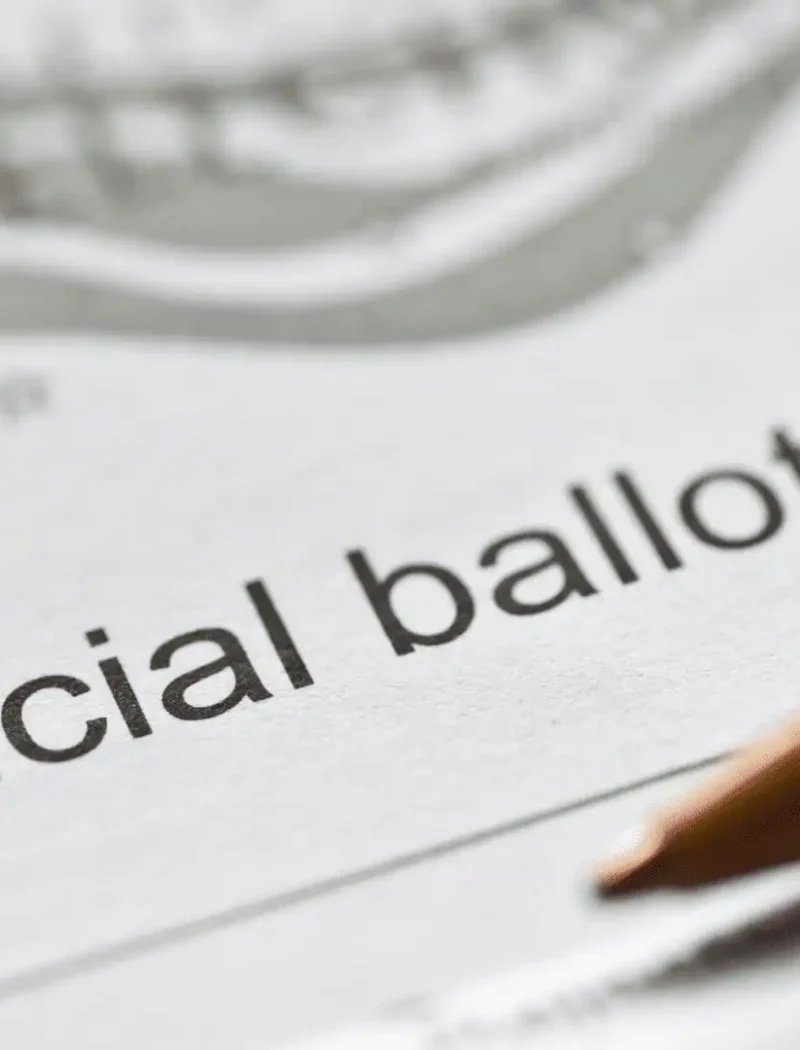Montana Secretary of State Christi Jacobsen certifies candidates 10 A close-up of an official ballot paper with the words Official ballot clearly visible. A red and white pen rests on the paper, suggesting someone is about to fill it out as Montana Secretary of State Christi Jacobsen certifies candidates.