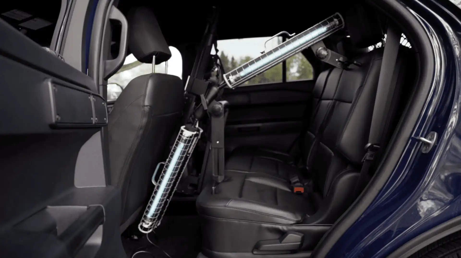 A car’s back seat with ultraviolet light disinfectant devices installed inside, aimed at sterilizing the interior, especially the rear area and seats.