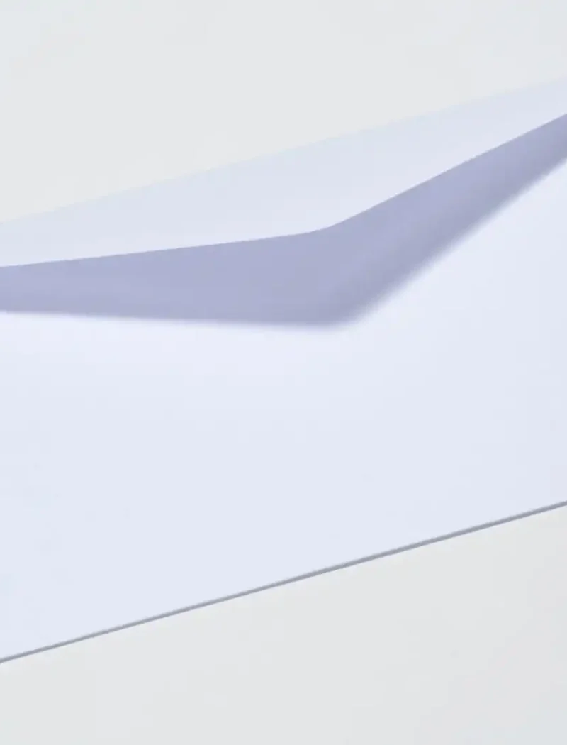 A white envelope is shown on a plain light background with its flap partially open, resembling the misleading mailings often received by newly registered businesses, such as those flagged by the Montana Secretary of State.