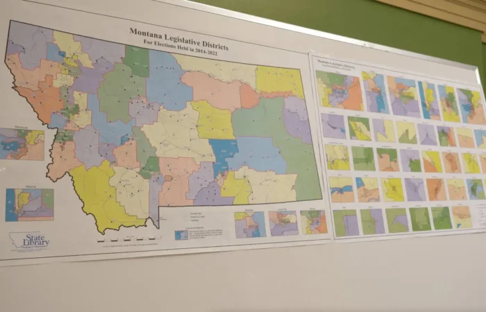 Montana Secretary of State's Office receives 15 new candidate filings this week 5 A whiteboard displays two posters with colorful maps of Montana legislative districts, highlighting various regions and districts, including a large detailed map and smaller inset maps on the right, relevant to election and 2022 candidate filing.