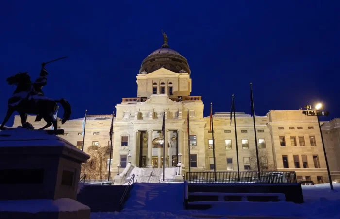 Secretary Christi Jacobsen: Montana on track for another record year of new business registrations 1 The illuminated Montana State Capitol building is seen at night with snow on the ground. A bronze equestrian statue stands in the foreground, and several flags are displayed—symbolizing Montana’s commitment to implement a secure election management system.