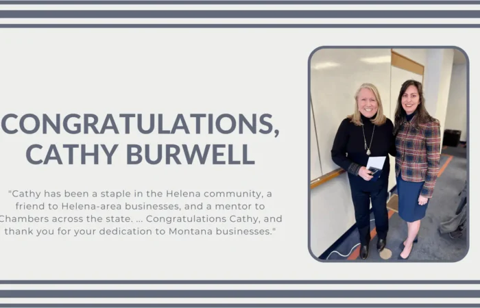 Two women stand smiling in an office setting. A message beside them reads, CONGRATULATIONS, CATHY BURWELL, honoring her dedication to Helena-area businesses and the Helena Chamber.