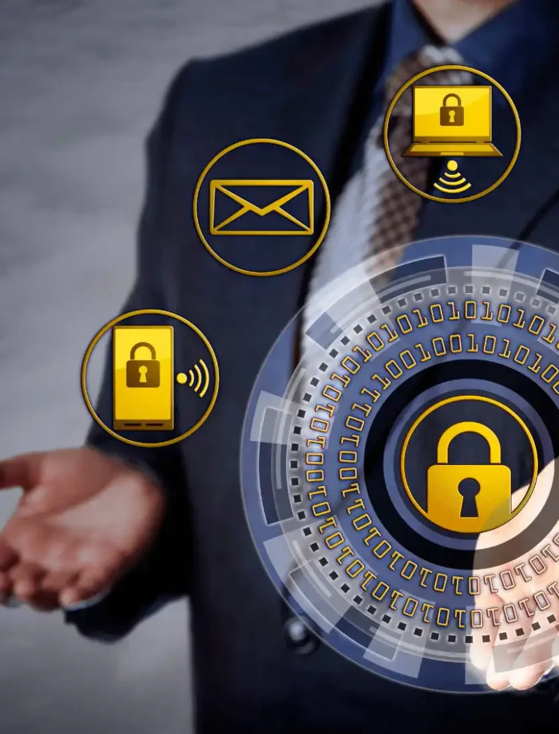 A businessperson in a suit stands with open hands; digital icons represent cybersecurity threats like locks, cloud storage, email, and Wi-Fi—highlighting how Montana businesses must stay vigilant against evolving digital risks.