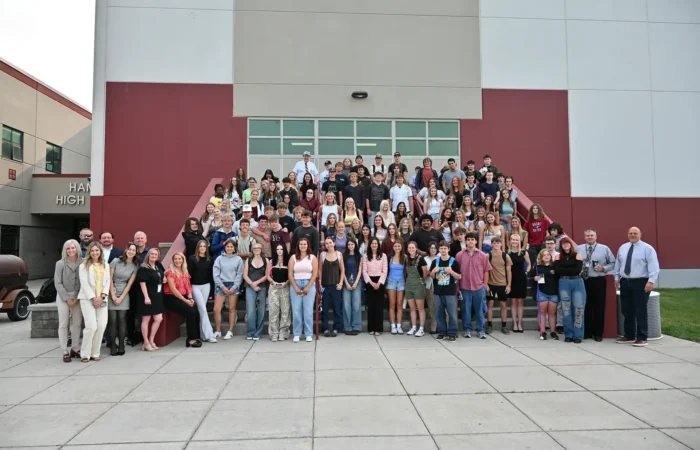 Secretary Christi Jacobsen launches fifth annual Constitution Contest 4 A large group of students and adults, including Secretary Christi Jacobsen, pose together on steps outside a school building, smiling for a group photo.