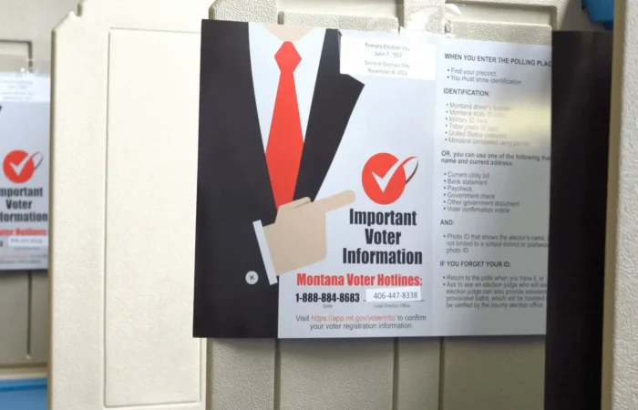 'Great quality control check': Secretary of State's Office provides updates on postelection audit, future election management system 6 A voter information flyer highlighting the Secretary of States Office with a red tie graphic and a checkmark is attached to a beige voting booth. In the background, its reflection appears on another booth. The flyer mentions Montana voter information hotlines.