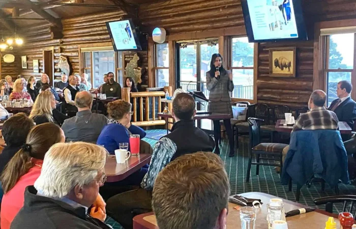 Secretary Christi Jacobsen: 'New business registrations rise again in March' 8 A woman speaks with a microphone in front of a group of people seated at tables in a rustic, log cabin-style room. A presentation on new business registrations is displayed on screens behind her, featuring Christi Jacobsen’s March report.