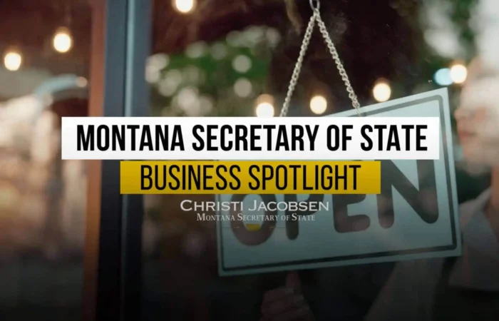 A person holds an Open sign at a storefront. Overlaid text reads: Montana Business Spotlight, highlighting Montana business success. Christi Jacobsen, Secretary of State.