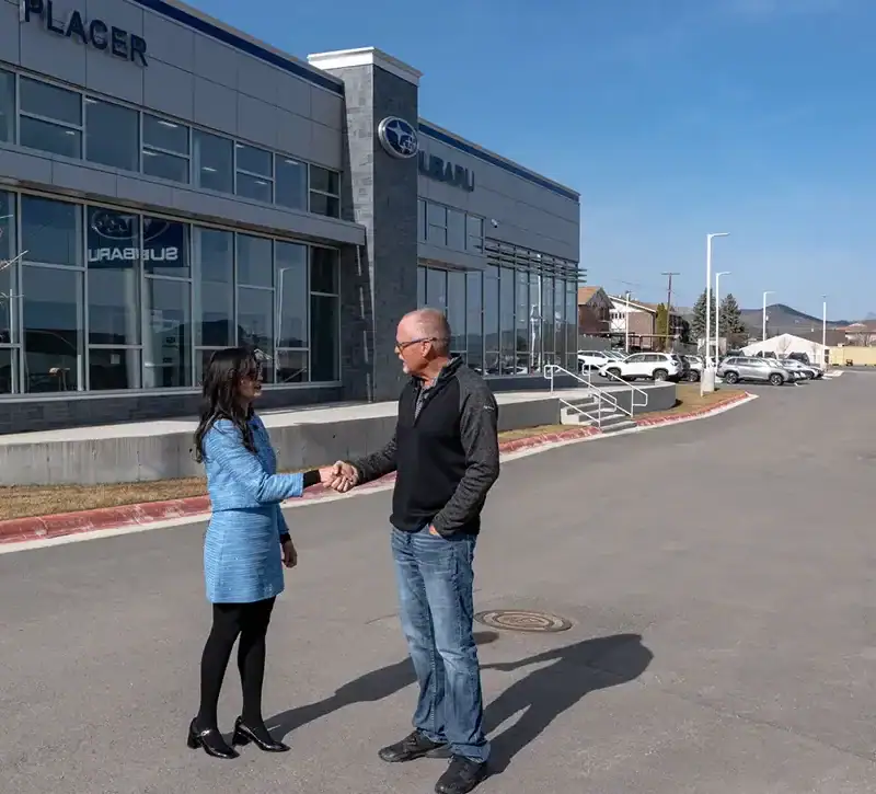 Montana Secretary of State Christi Jacobsen visits with Placer Motors owner Erick Anderson.