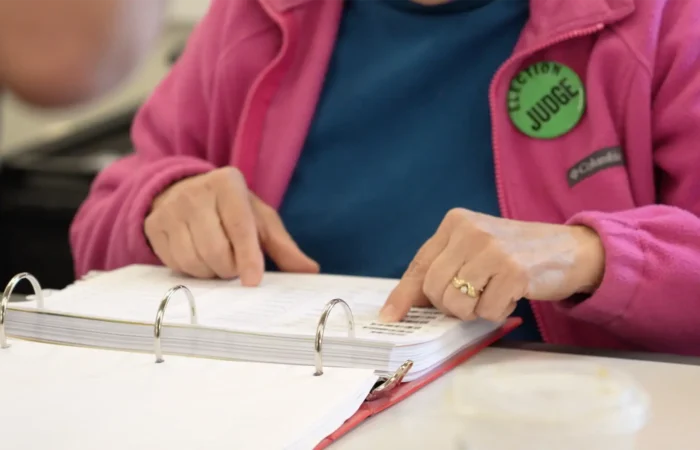 Secretary Christi Jacobsen: ‘Free SAVE tool flags hundreds of deceased voter records’ 5 An election judge searches through the poll book to find a voter.