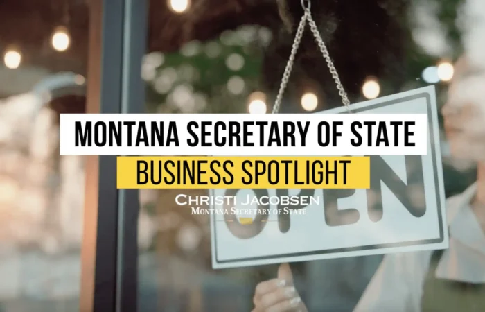 Montana Business Spotlight: Ghosts and geothermals part of the history at Boulder Hot Springs 3 A person flips an OPEN sign on a glass door. Overlaid text reads: Montana Secretary of State Business Spotlight. Christi Jacobsen, Montana Secretary of State.