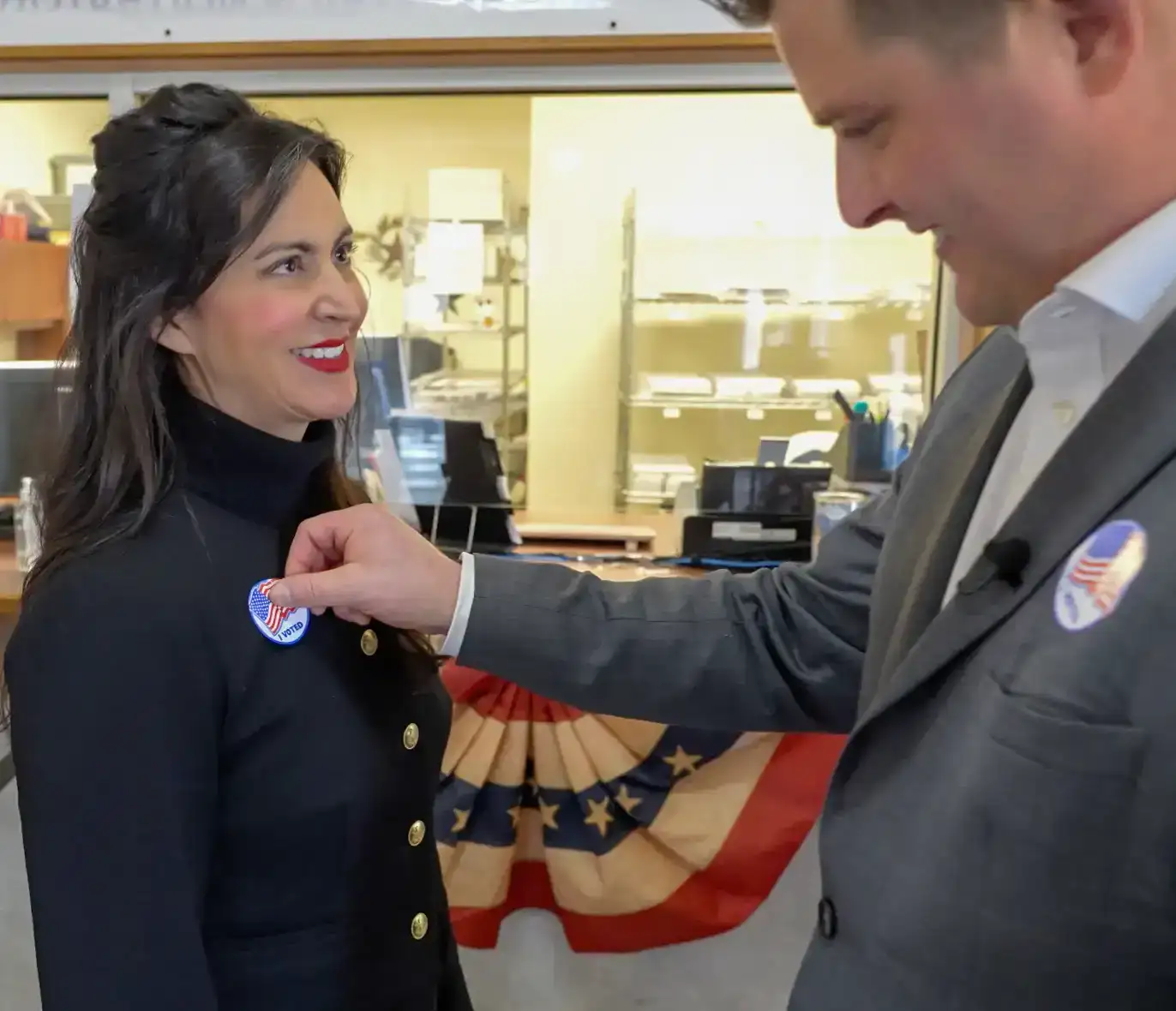 Montana Secretary of State Christi Jacobsen receives her "I Voted" sticker after casting her votes in a Montana election.