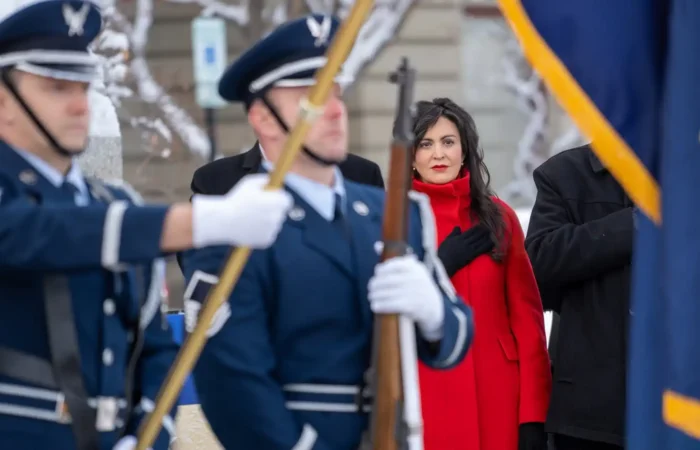 Secretary Christi Jacobsen to eliminate new business filing fees for veterans and active-duty military members 2 Montana Secretary of State Christi Jacobsen addresses the flags during the national anthem in front of the Montana State Capitol building.