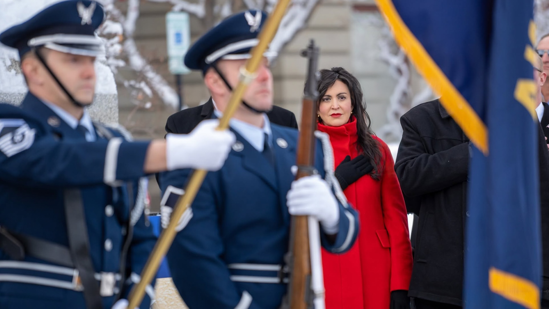Montana Secretary of State Christi Jacobsen addresses the flags during the national anthem in front of the Montana State Capitol building.