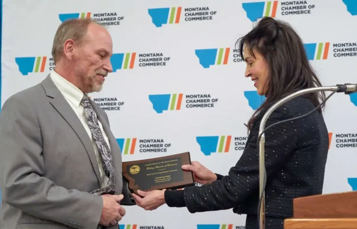 Montana Secretary of State Christi Jacobsen thanks businesses for successful 2024 annual report season 9 A woman presents a plaque to Montana Secretary of State Christi Jacobsen at a Montana Chamber of Commerce event. Both are smiling in front of a branded backdrop, with the 2024 annual report and podium visible on the right.