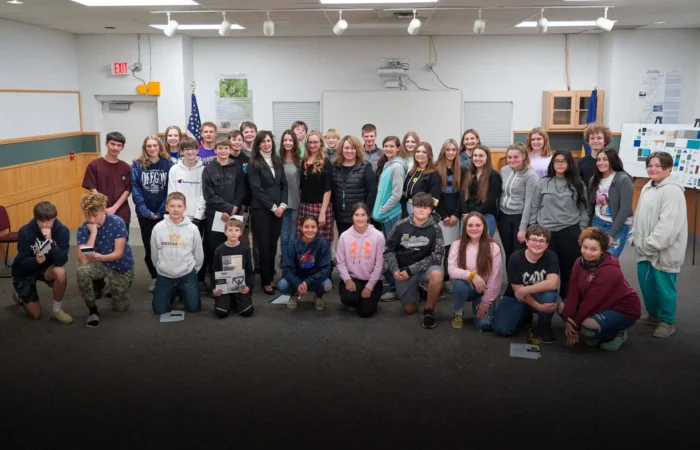 Townsend Middle School recognized for participation in US Constitution Contest 1 A large group of smiling teens and a few adults pose together in a Townsend Middle School classroom, standing and kneeling in rows. The background features a whiteboard, bulletin boards, and US Constitution Contest materials.