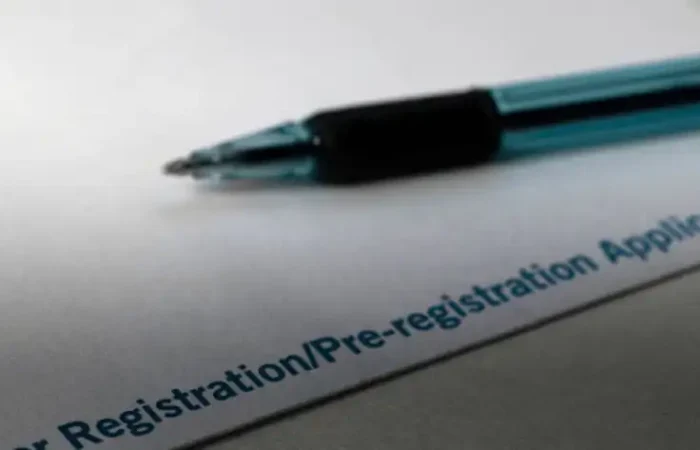 Secretary Jacobsen releases more detailed late voter registration activities report 2 A blue pen rests on a sheet of paper with the partially visible text Registration/Pre-registration Application, provided by the Montana Secretary of State, printed in blue in the bottom-right corner.